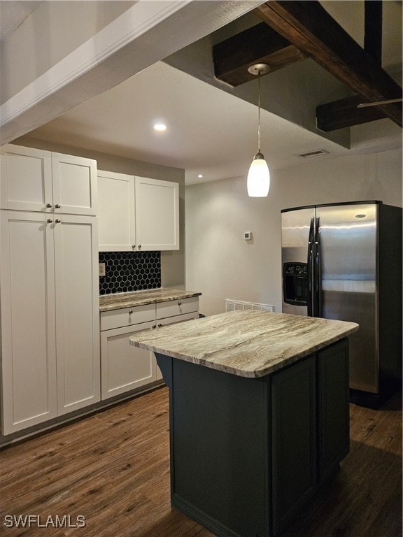 kitchen with stainless steel fridge, dark hardwood / wood-style floors, white cabinetry, and hanging light fixtures