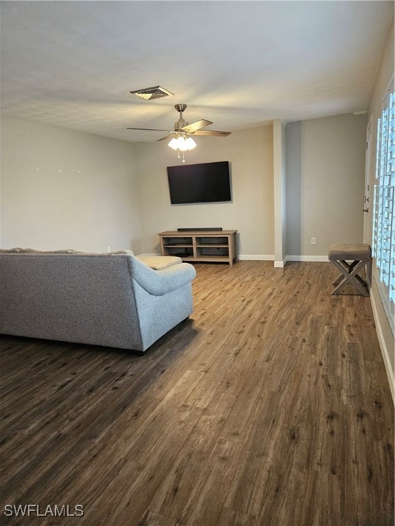 living room with wood-type flooring and ceiling fan