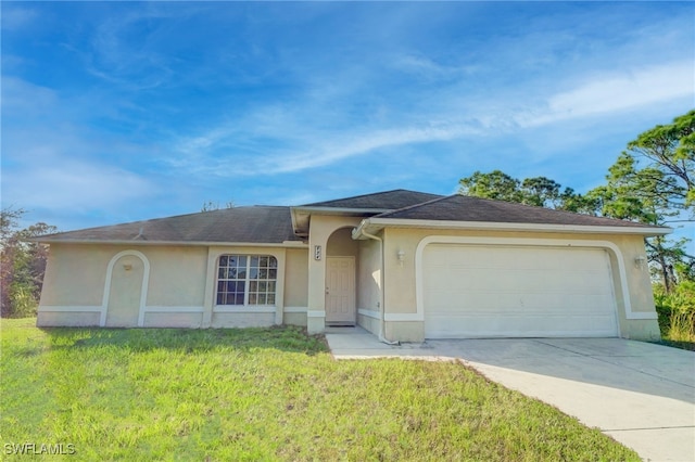 ranch-style house featuring a front yard and a garage