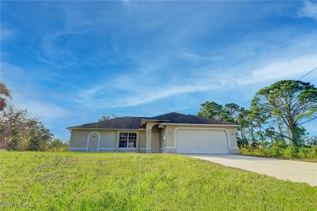 ranch-style house featuring a front lawn and a garage