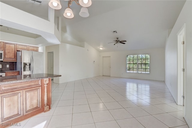 kitchen featuring tasteful backsplash, white appliances, light tile patterned floors, and vaulted ceiling