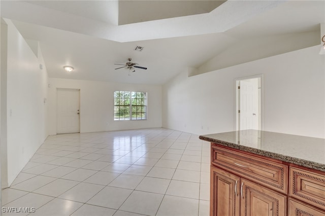 tiled spare room with ceiling fan and lofted ceiling