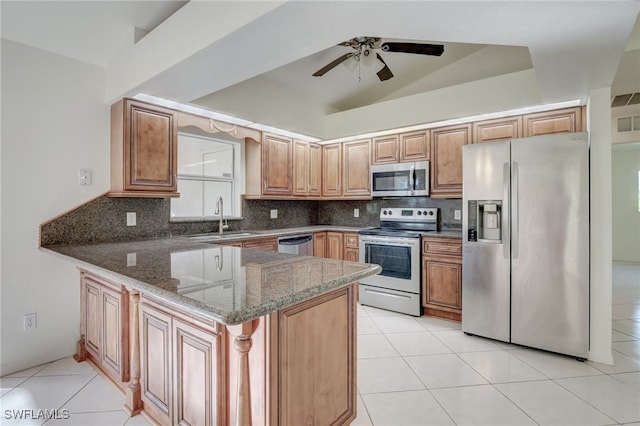 kitchen featuring sink, stainless steel appliances, backsplash, kitchen peninsula, and dark stone countertops