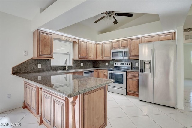 934 Garnet Ave, Lehigh Acres, FL 33974 - kitchen featuring appliances with stainless steel finishes, a sink, stone counters, a peninsula, and backsplash