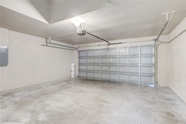 garage with electric panel and a garage door opener