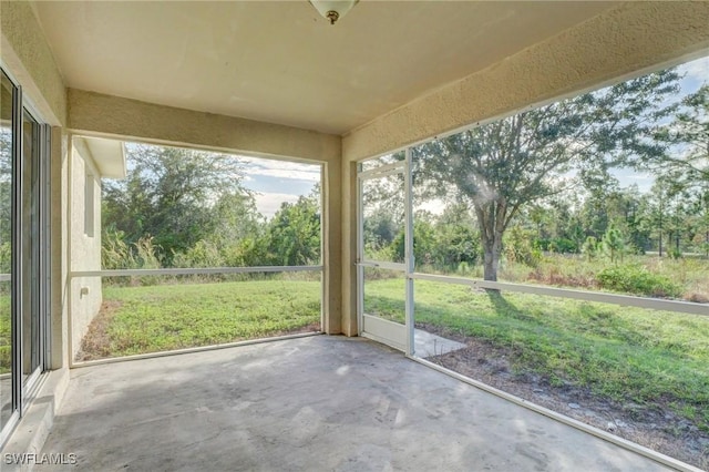 934 Garnet Ave, Lehigh Acres, FL 33974 - unfurnished sunroom with view of scattered trees