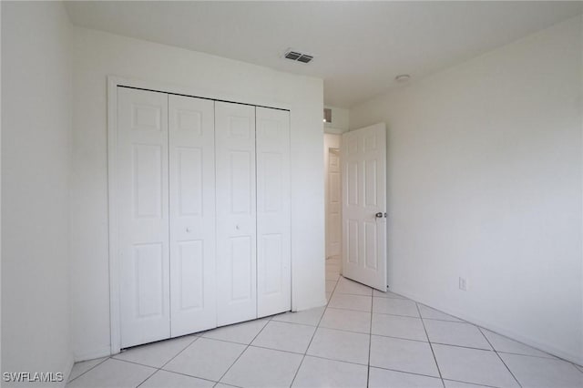 934 Garnet Ave, Lehigh Acres, FL 33974 - unfurnished bedroom featuring light tile patterned floors and a closet