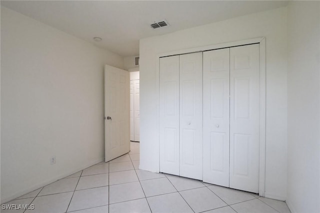 934 Garnet Ave, Lehigh Acres, FL 33974 - unfurnished bedroom featuring a closet and light tile patterned floors