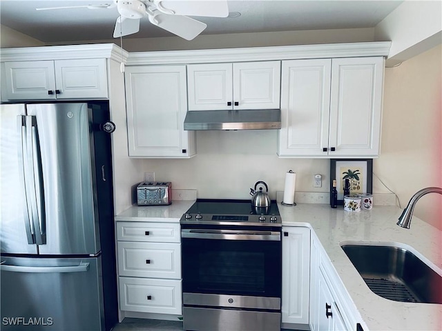 kitchen featuring light stone counters, sink, white cabinets, and appliances with stainless steel finishes