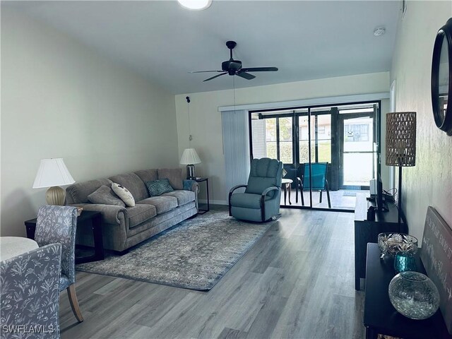 living room featuring hardwood / wood-style floors and ceiling fan