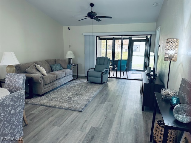 living room featuring hardwood / wood-style floors and ceiling fan