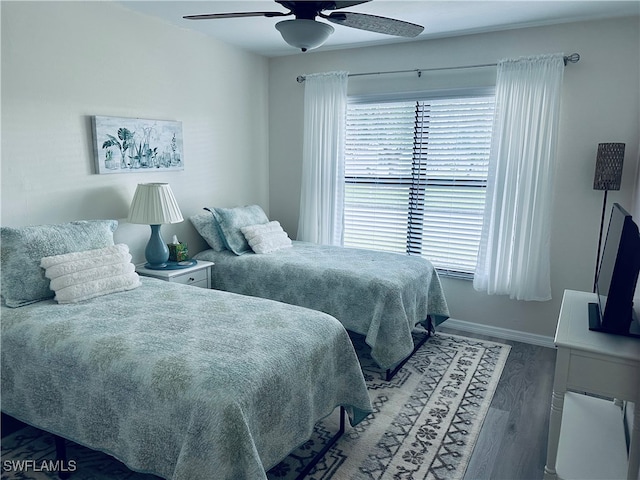 bedroom with wood-type flooring and ceiling fan