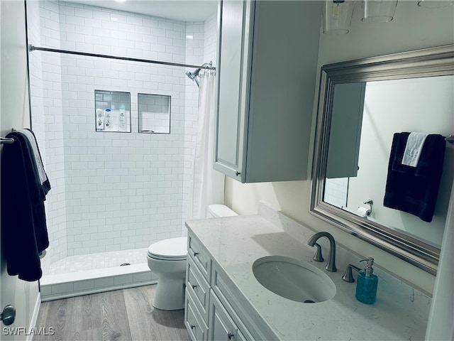 bathroom with toilet, hardwood / wood-style floors, vanity, and a shower with curtain