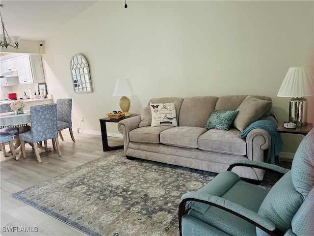 living room featuring a chandelier and light wood-type flooring