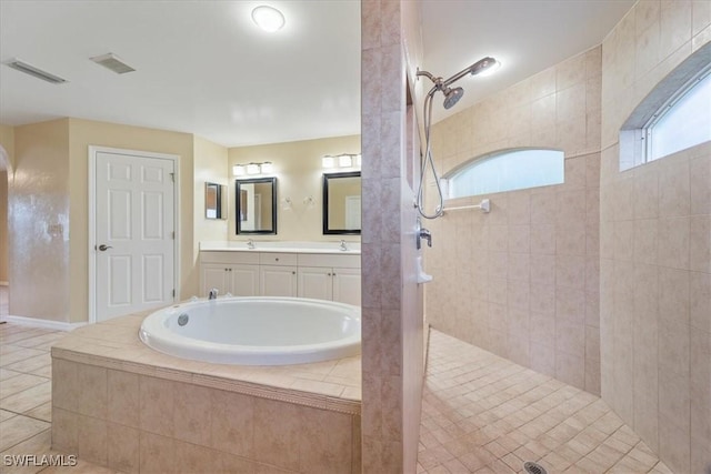 bathroom featuring tile patterned floors, vanity, and shower with separate bathtub