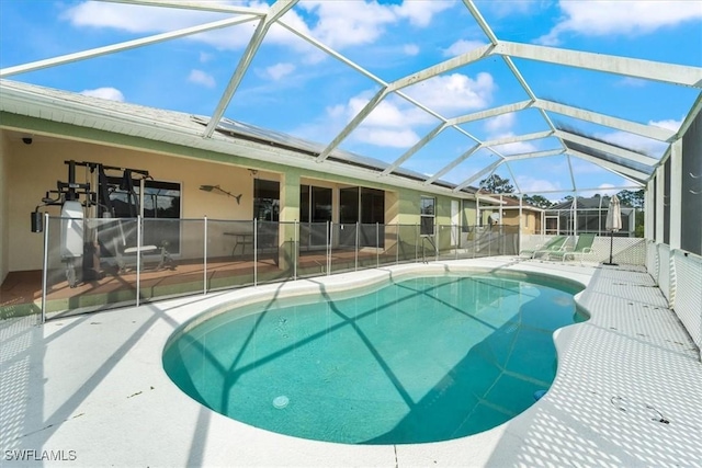 view of swimming pool featuring a patio and a lanai