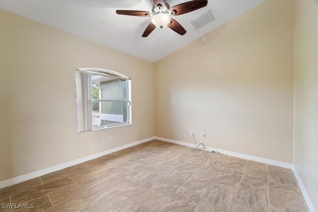 empty room featuring ceiling fan and vaulted ceiling