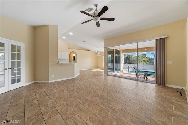 unfurnished living room featuring ceiling fan, french doors, and lofted ceiling