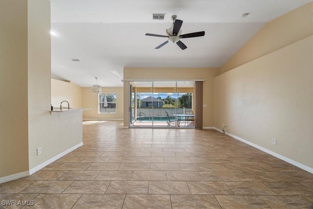 unfurnished living room featuring sink, ceiling fan with notable chandelier, and lofted ceiling