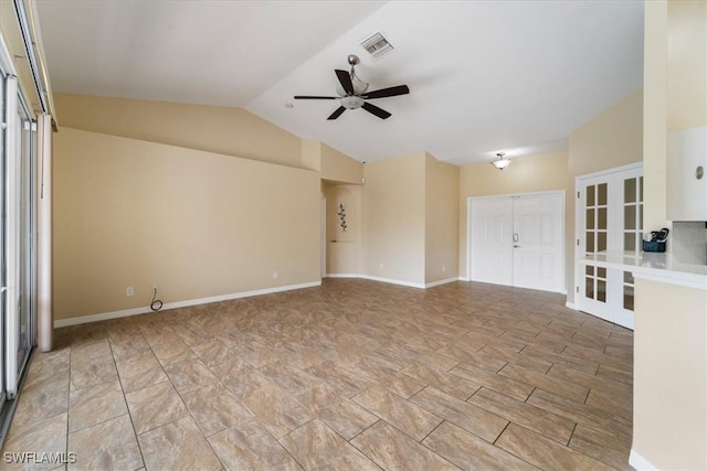 unfurnished room featuring ceiling fan, french doors, and vaulted ceiling