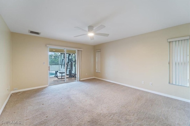 spare room featuring carpet and ceiling fan