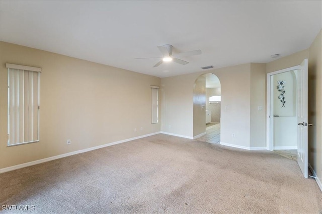 carpeted spare room featuring ceiling fan