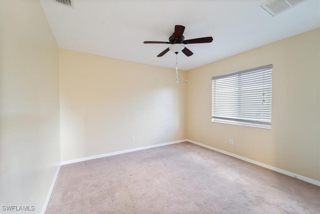 carpeted spare room with ceiling fan