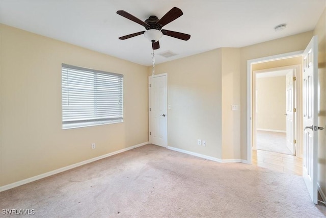 empty room featuring light colored carpet and ceiling fan