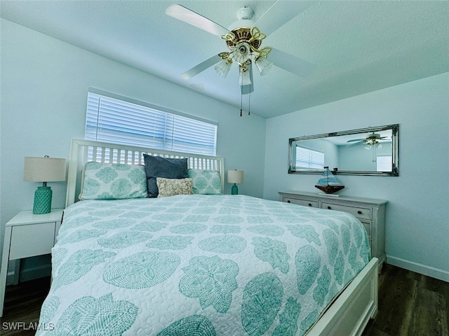 bedroom featuring ceiling fan and dark hardwood / wood-style flooring