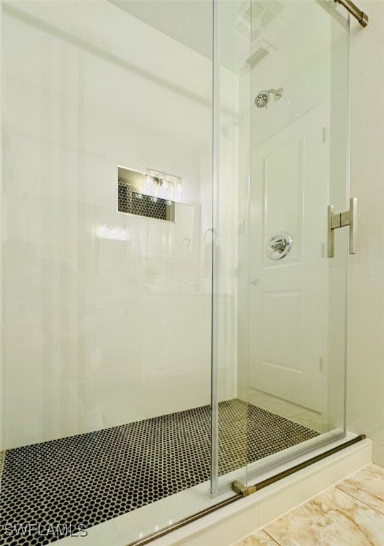 bathroom with a shower with door