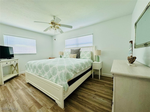 bedroom featuring ceiling fan and dark hardwood / wood-style flooring