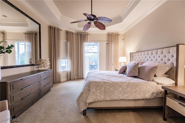 bedroom with multiple windows, ornamental molding, light colored carpet, and a raised ceiling