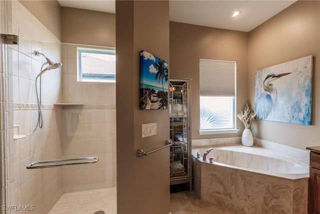 bathroom with vanity, shower with separate bathtub, and a healthy amount of sunlight