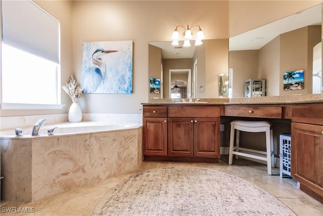 bathroom featuring vanity, a washtub, and tile patterned floors