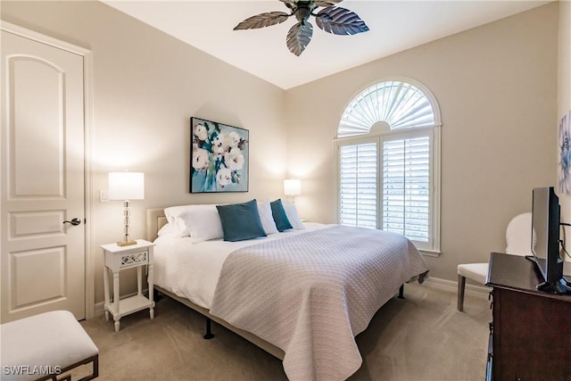 bedroom featuring light carpet and ceiling fan