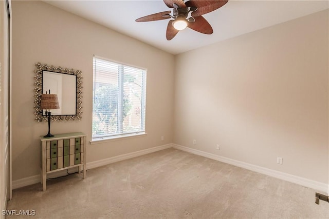 empty room with ceiling fan and light colored carpet