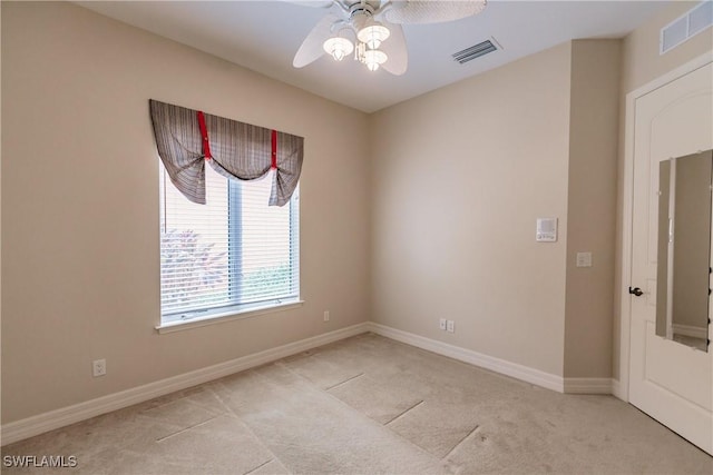 unfurnished room featuring ceiling fan and light colored carpet