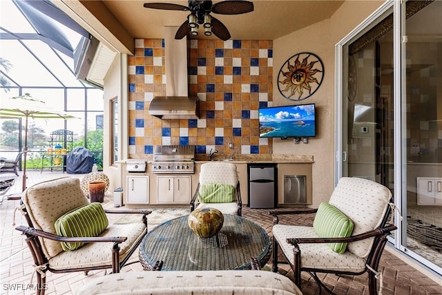 sunroom / solarium with ceiling fan and sink