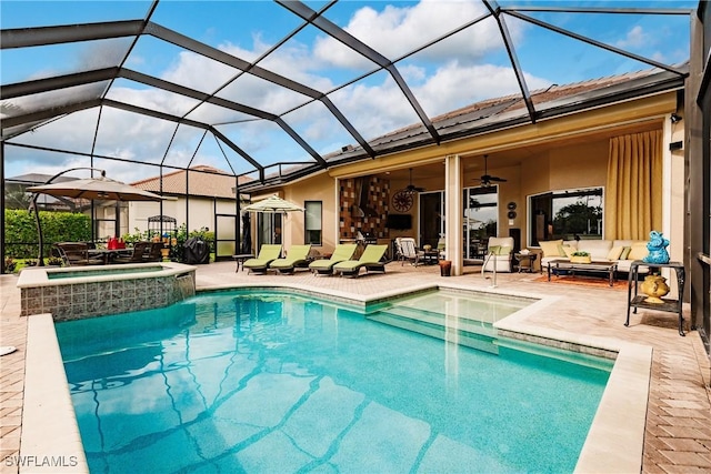 view of pool featuring an in ground hot tub, outdoor lounge area, glass enclosure, and a patio