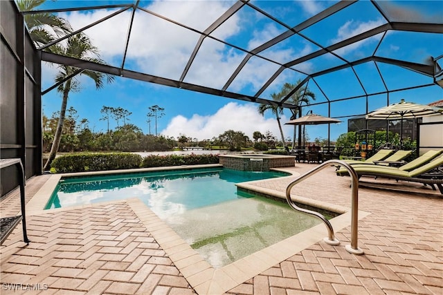 view of pool with a lanai, a patio area, and an in ground hot tub