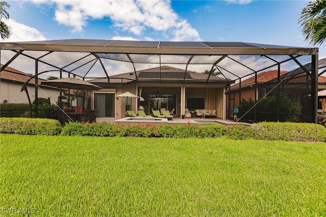 back of property featuring a patio, a lanai, and a lawn