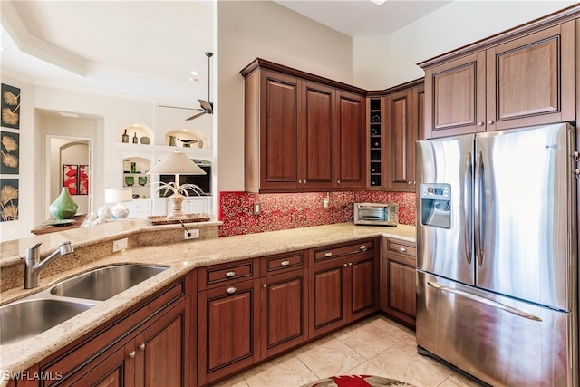 kitchen with sink, stainless steel fridge with ice dispenser, light tile patterned floors, light stone countertops, and backsplash