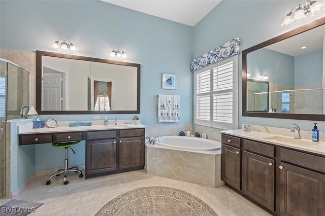 bathroom with tile patterned floors, vanity, and separate shower and tub