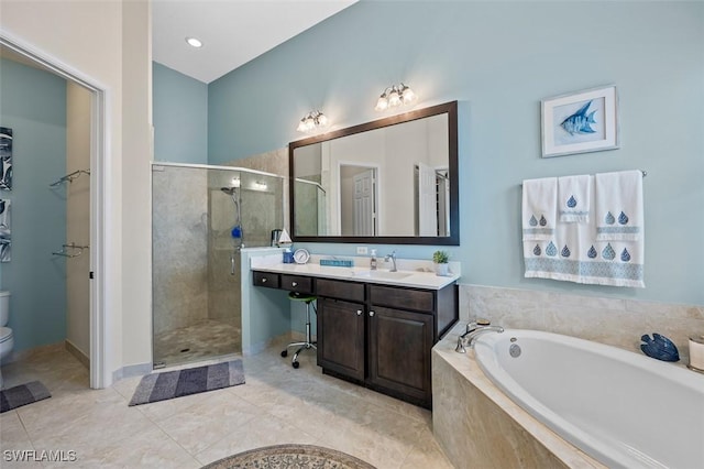 full bathroom featuring a garden tub, toilet, a shower stall, vanity, and tile patterned flooring