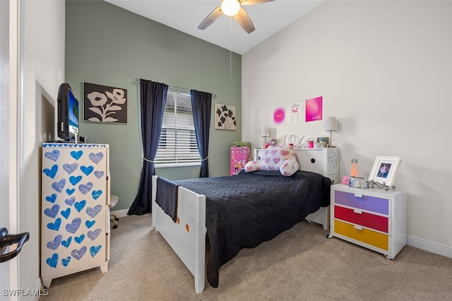 bedroom featuring ceiling fan, light colored carpet, and lofted ceiling