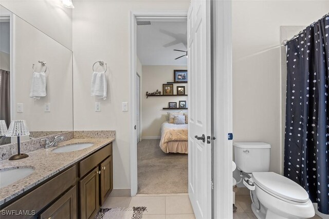 bathroom with vanity, tile patterned flooring, ceiling fan, toilet, and curtained shower