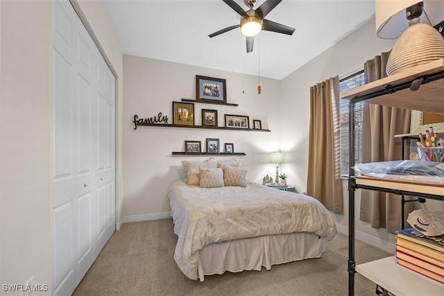 carpeted bedroom featuring ceiling fan and a closet