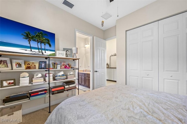 bedroom featuring a closet, ensuite bath, visible vents, and light colored carpet