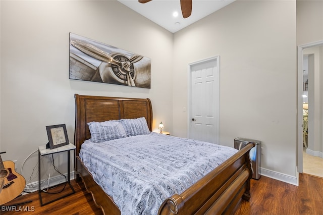 bedroom with ceiling fan and dark wood-type flooring