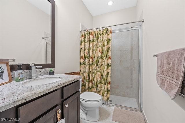 bathroom featuring tile patterned flooring, vanity, toilet, and tiled shower